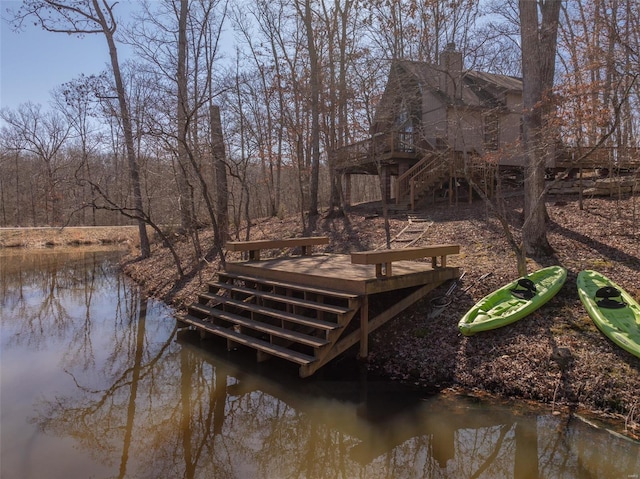 dock area with stairway and a deck with water view