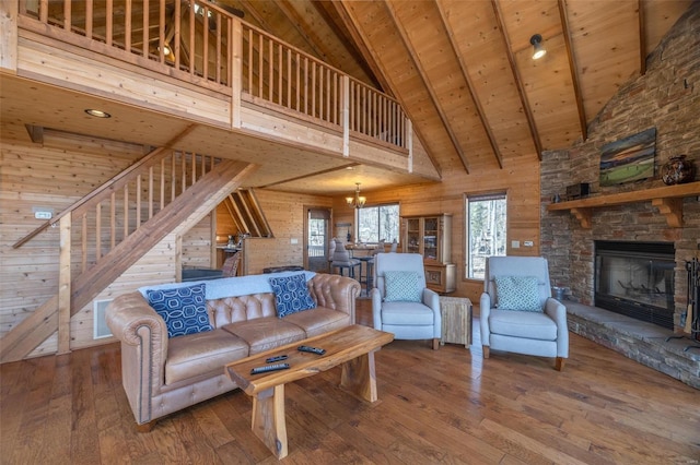 living room with wooden walls, wooden ceiling, stairs, and wood-type flooring