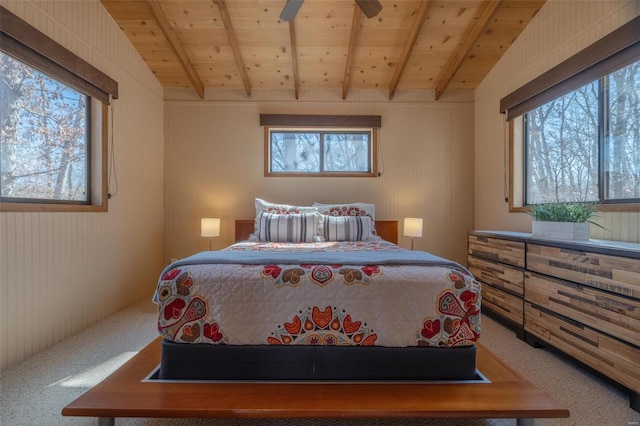 bedroom with wooden ceiling, vaulted ceiling with beams, and carpet