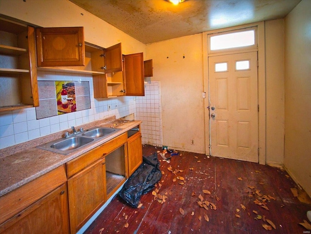 kitchen with dark wood-style flooring, open shelves, backsplash, brown cabinetry, and a sink