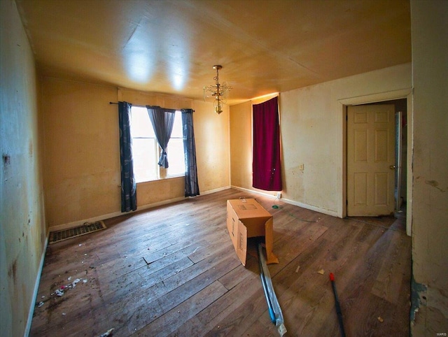 empty room with hardwood / wood-style flooring and baseboards