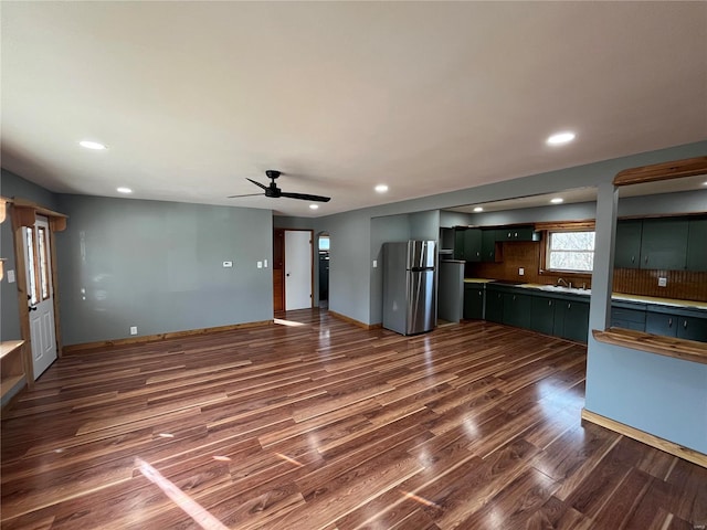 unfurnished living room with dark wood-style floors, ceiling fan, baseboards, and recessed lighting