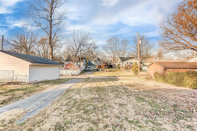 view of yard with a residential view and fence