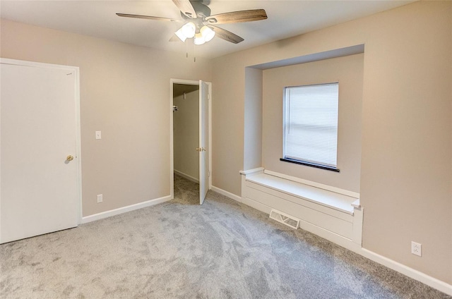 unfurnished bedroom featuring a spacious closet, visible vents, baseboards, and carpet floors