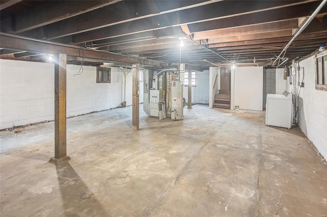 basement with washer / dryer, stairway, and gas water heater