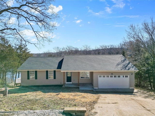 ranch-style home featuring an attached garage, covered porch, concrete driveway, and roof with shingles