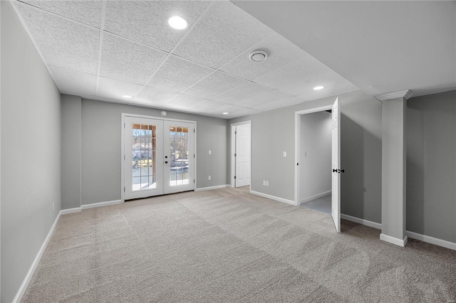 carpeted spare room with recessed lighting, baseboards, a drop ceiling, and french doors