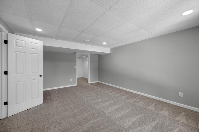 finished basement with recessed lighting, carpet flooring, a paneled ceiling, and baseboards