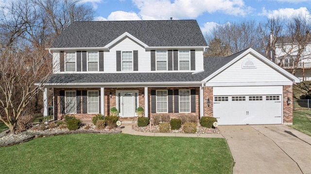 traditional-style home featuring driveway, an attached garage, covered porch, a front yard, and brick siding