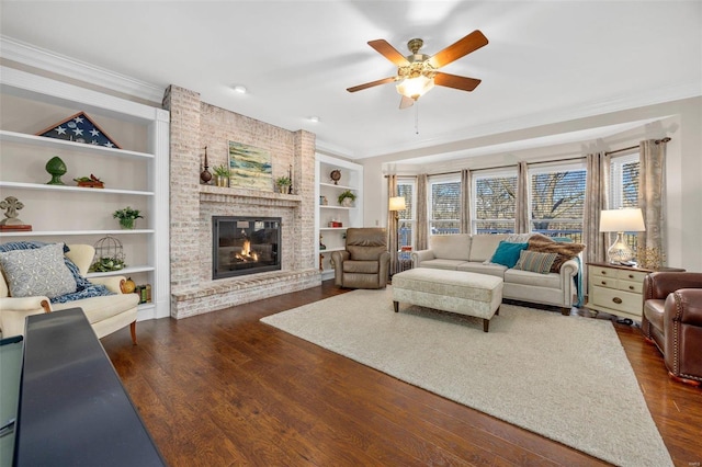 living area with crown molding, built in shelves, and dark wood-type flooring