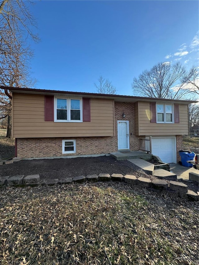 split foyer home with brick siding and an attached garage