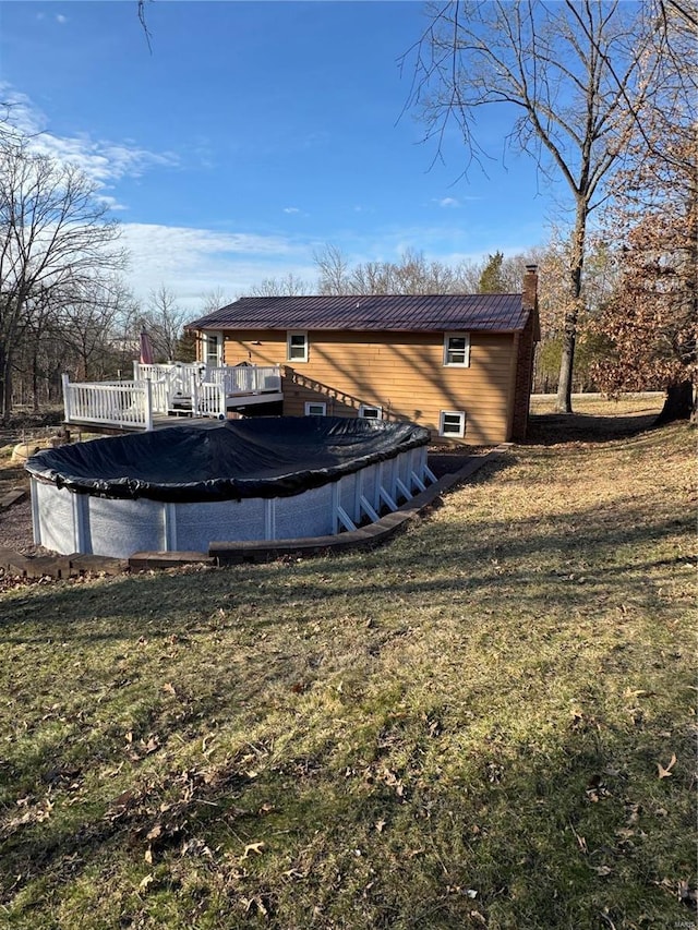 view of pool featuring a covered pool, a yard, and a wooden deck