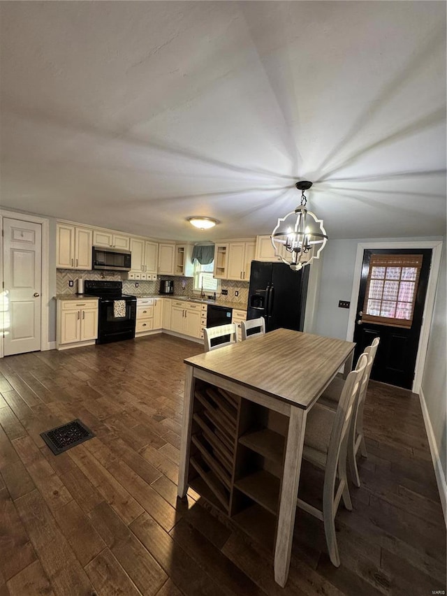 dining space with an inviting chandelier, baseboards, visible vents, and dark wood-style flooring