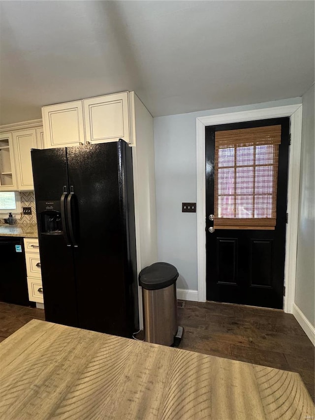 kitchen featuring white cabinetry, baseboards, dark wood-style floors, black appliances, and tasteful backsplash