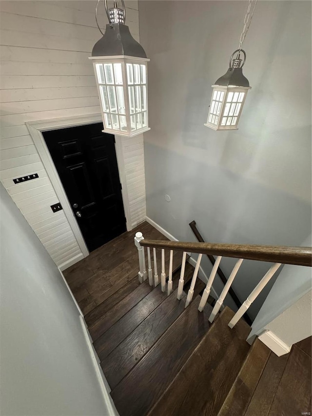 staircase featuring baseboards and hardwood / wood-style flooring