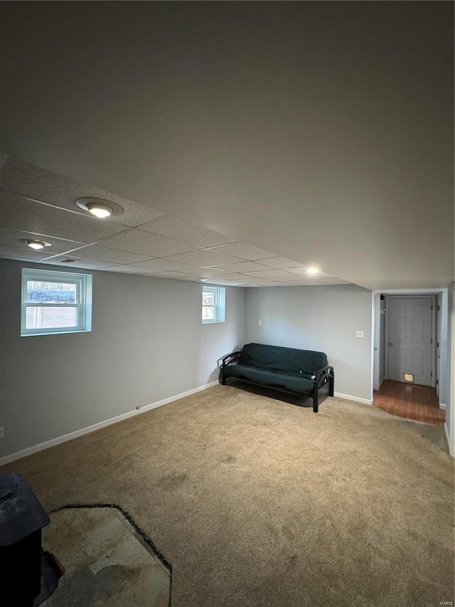 unfurnished room with carpet floors, baseboards, and a paneled ceiling