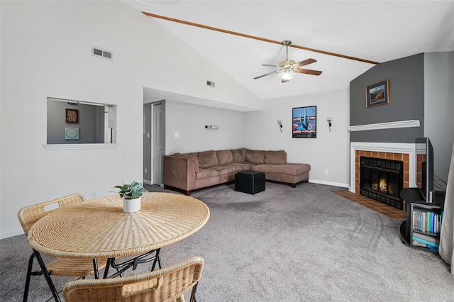 carpeted living room featuring lofted ceiling, visible vents, and a tiled fireplace