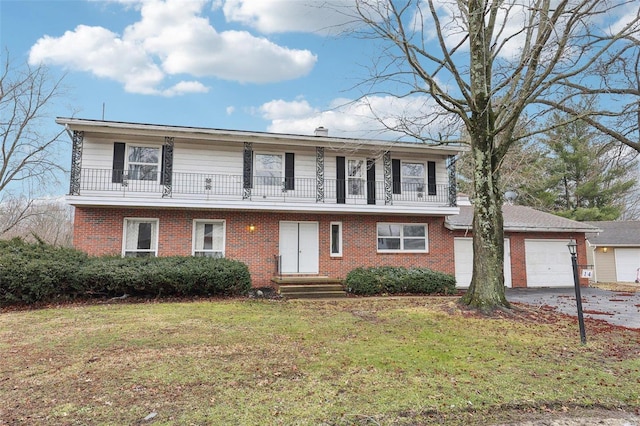 view of front facade with a balcony, a garage, a front lawn, and brick siding