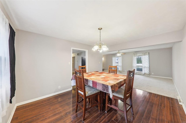 dining area featuring dark wood-style floors, a notable chandelier, and baseboards