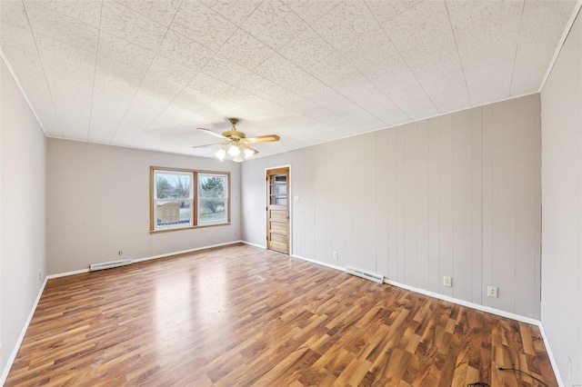 unfurnished room featuring wood finished floors, visible vents, and a ceiling fan