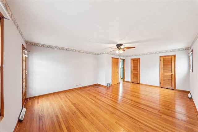 unfurnished bedroom with light wood-style flooring, visible vents, a ceiling fan, multiple closets, and baseboards