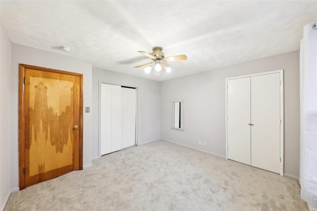 unfurnished bedroom with carpet floors, a ceiling fan, and baseboards