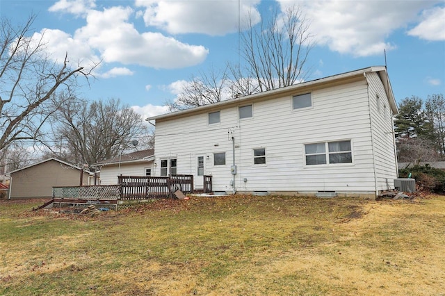 rear view of property featuring a deck, central AC, and a lawn