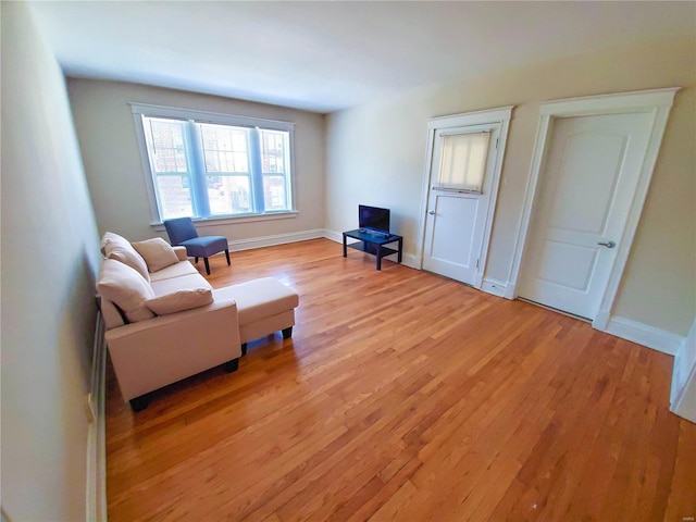 sitting room with light wood-style flooring and baseboards