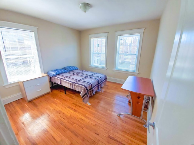 bedroom featuring light wood-type flooring and baseboards