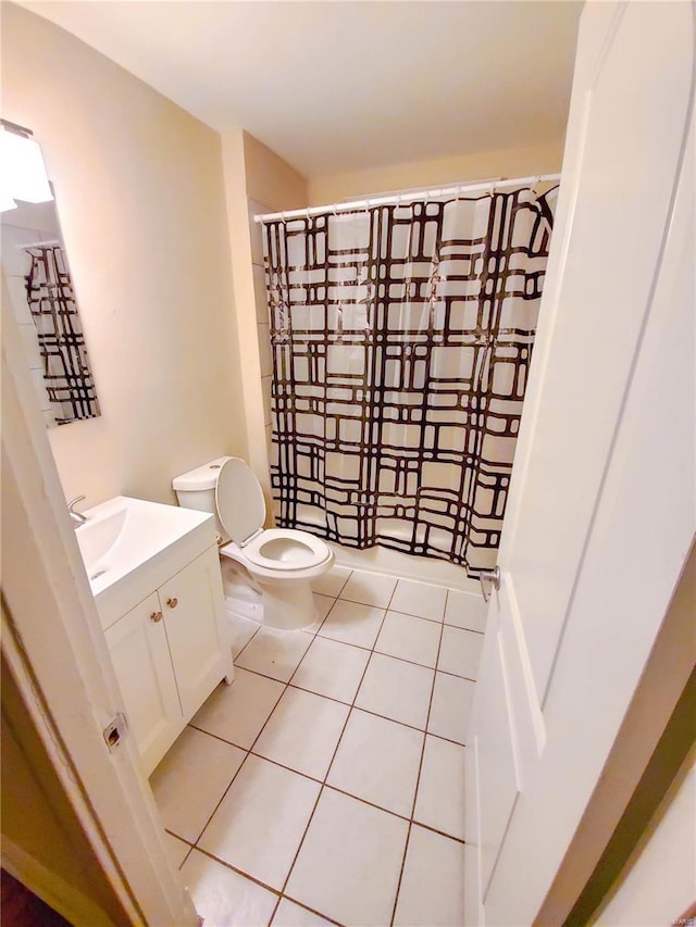 bathroom featuring vanity, curtained shower, tile patterned flooring, and toilet