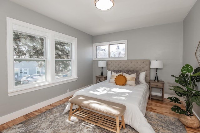 bedroom featuring baseboards and wood finished floors