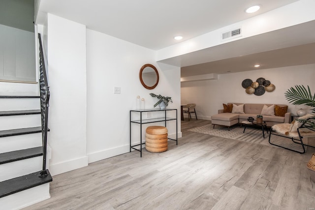 living room featuring stairway, wood finished floors, visible vents, baseboards, and recessed lighting