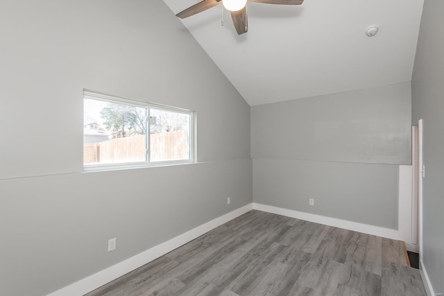 bonus room with high vaulted ceiling, wood finished floors, baseboards, and ceiling fan