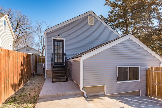 back of house with entry steps, a patio, and a fenced backyard