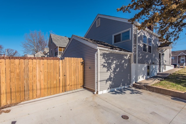 view of side of property featuring a patio area and fence