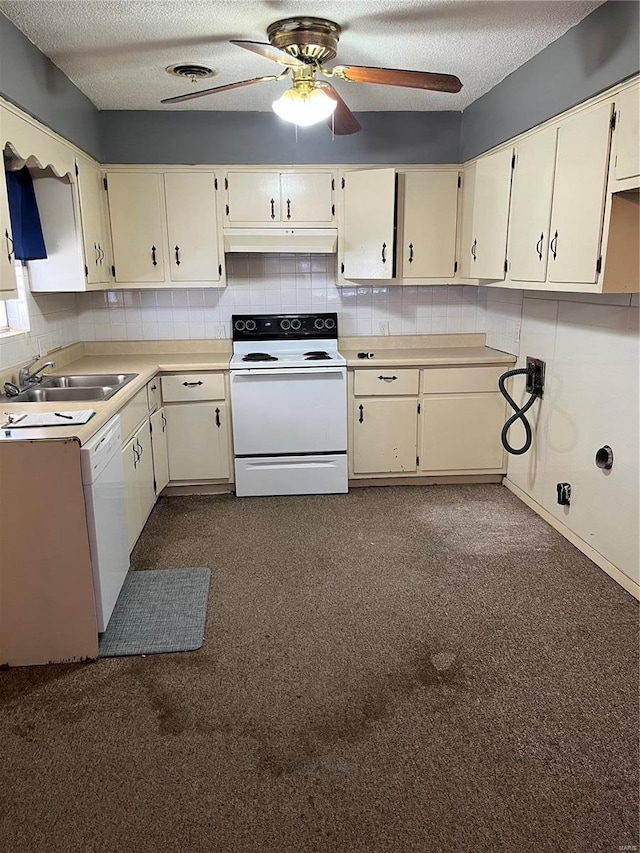 kitchen featuring white appliances, visible vents, decorative backsplash, under cabinet range hood, and a sink