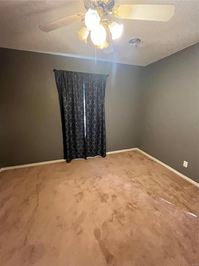 spare room with ceiling fan, a textured ceiling, baseboards, and carpet flooring