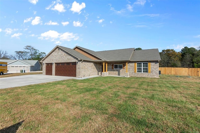 view of front of home with brick siding, a front lawn, fence, concrete driveway, and an attached garage