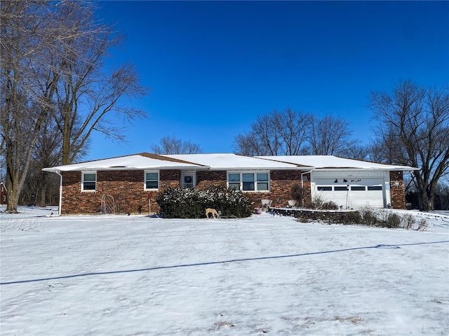 view of front facade with a garage and brick siding