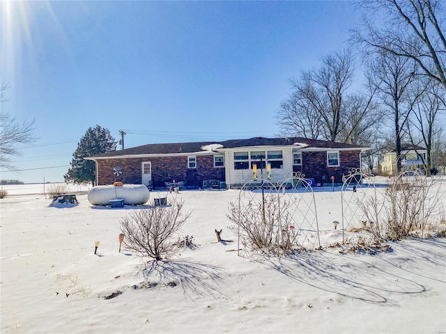 view of snow covered rear of property