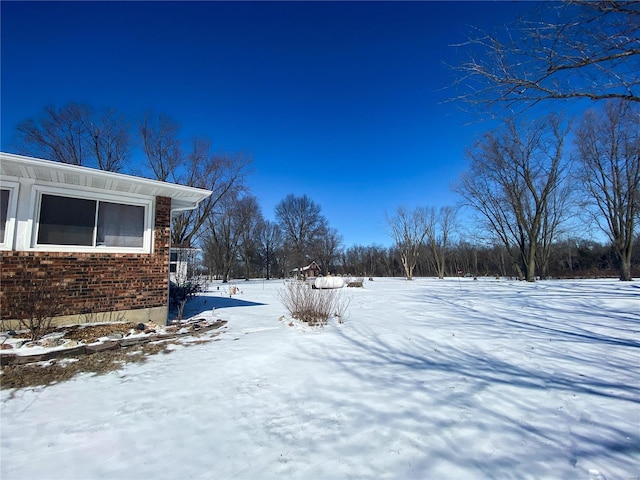 view of yard layered in snow