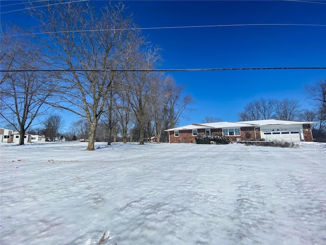 view of front of home with a garage and brick siding