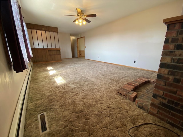 carpeted empty room with baseboards, visible vents, baseboard heating, and ceiling fan