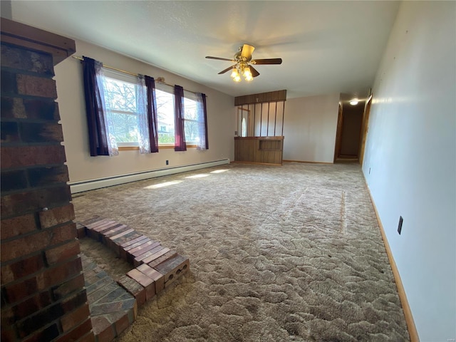 unfurnished living room with baseboards, a baseboard heating unit, a ceiling fan, and carpet floors