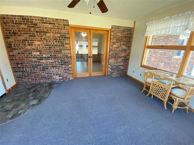 unfurnished sunroom featuring french doors and ceiling fan