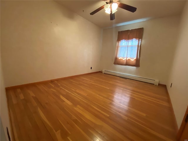 spare room featuring baseboard heating, ceiling fan, baseboards, and light wood-style floors