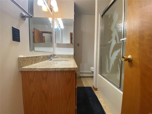 full bath featuring combined bath / shower with glass door, a baseboard radiator, toilet, and vanity