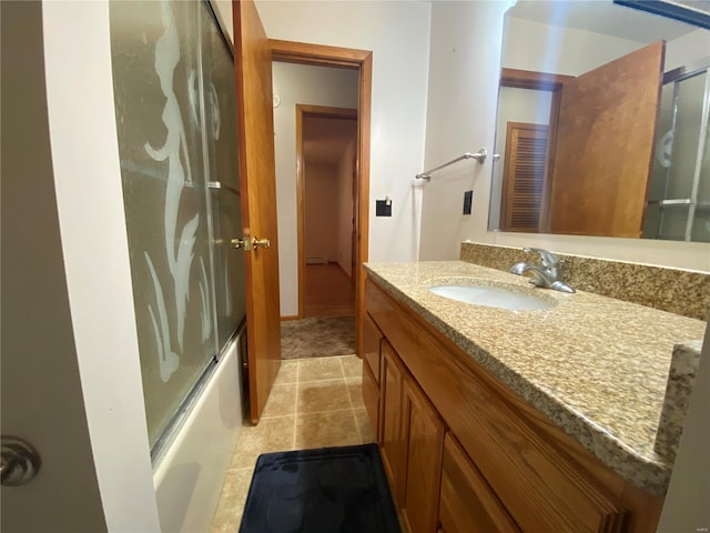 full bath featuring tile patterned flooring, vanity, and enclosed tub / shower combo