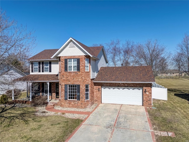 traditional-style house with brick siding, a garage, driveway, and a front lawn