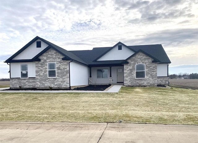 view of front facade featuring stone siding and a front yard